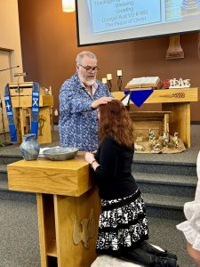 Minister baptising a congregant
